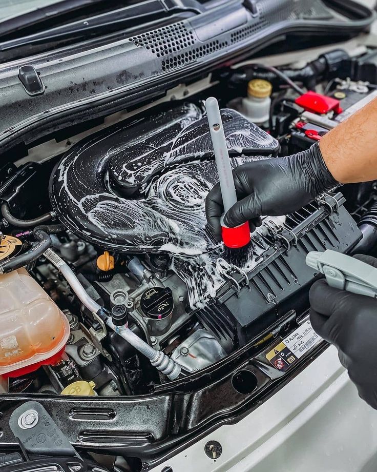 Engine bay cleaning with brush and foam for precision detailing