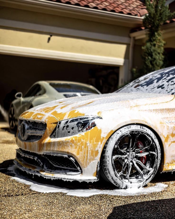 Yellow Mercedes covered in foam during premium wash service